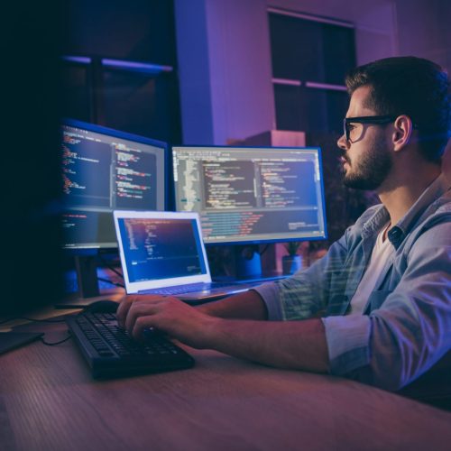 Profile side view portrait of his he nice attractive skilled smart focused, concentrated guy consultant writing script creating new digital desktop app in dark room workplace station indoors
